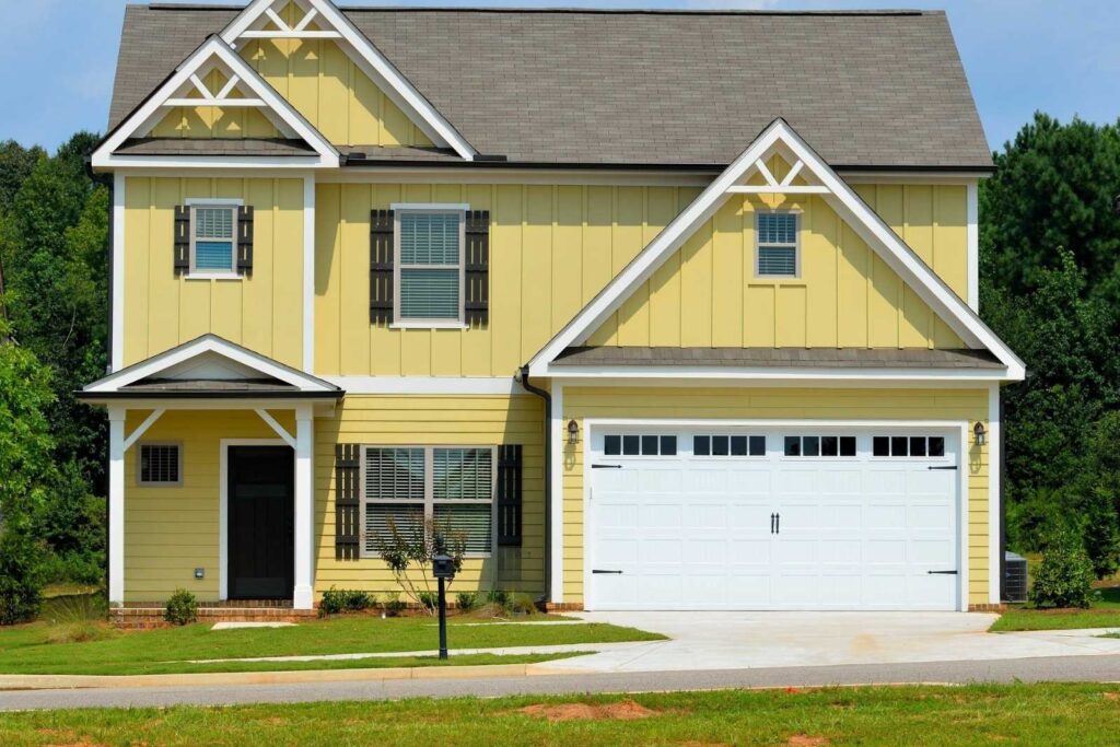 Sell house as is Alpharetta GA – yellow two-story home with garage, ready for quick cash sale